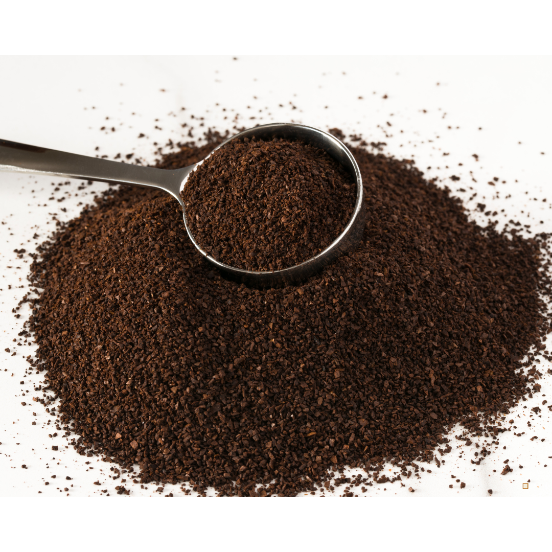 decaf ground coffee grounds on a table with a scoop