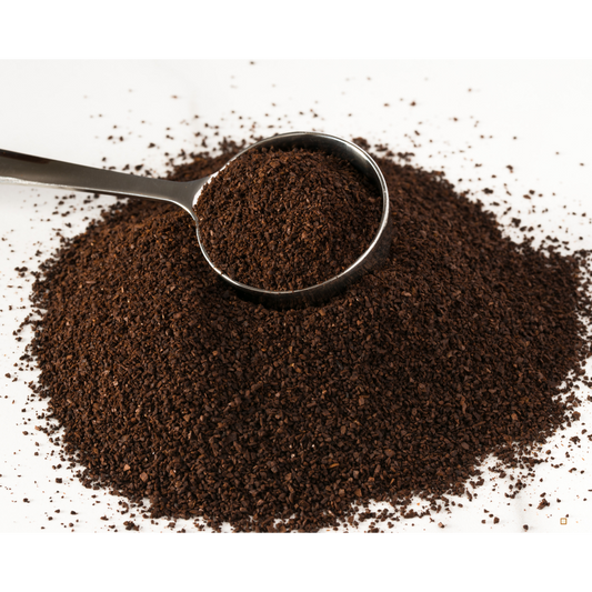 decaf ground coffee grounds on a table with a scoop