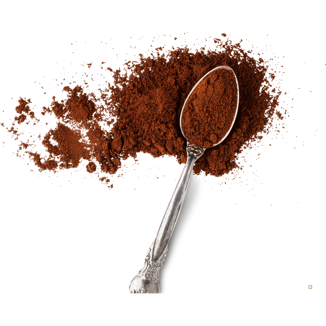 decaf ground coffee in a spoon on a white table top