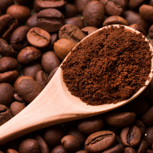 decaf ground coffee in a wooden scoop