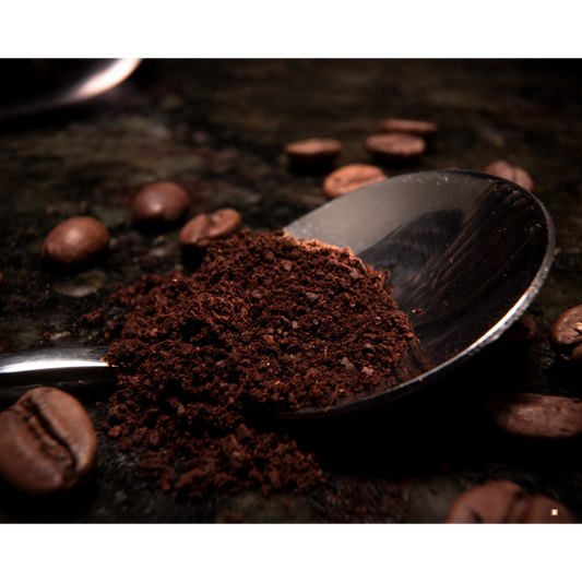 decaf ground coffee portion in a spoon on a table with coffee beans
