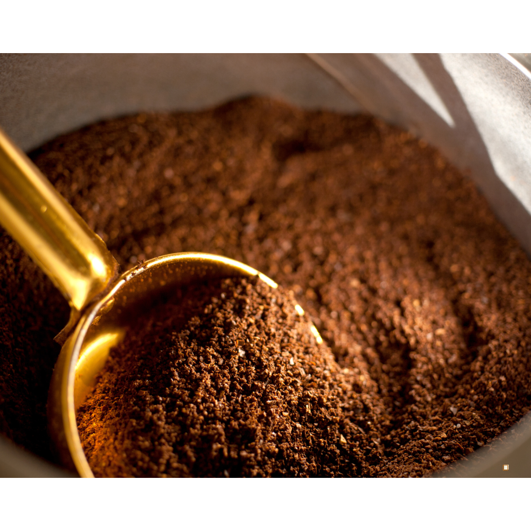decaf ground coffee with chaff specs and wooden scoop