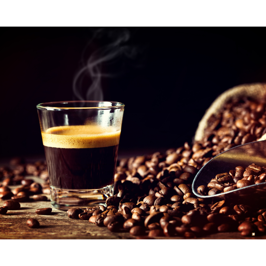 ethiopian yirgacheffe coffee in a clear glass mug surrounded by coffee beans