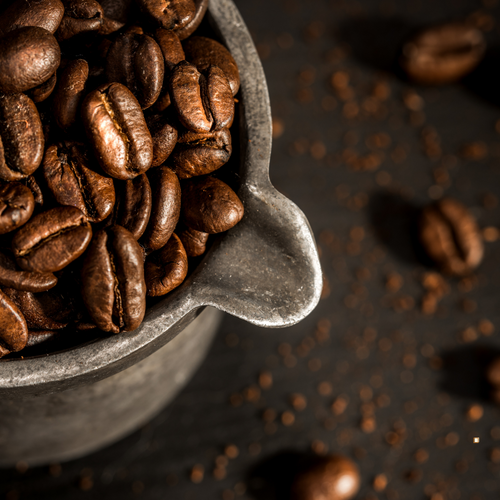 french dark roast coffee beans in pewter cup