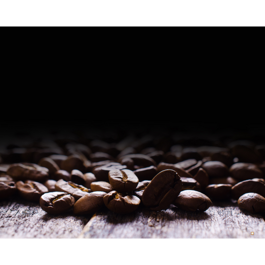 small batch roasted whole bean decaf coffee in the light fading to darkness