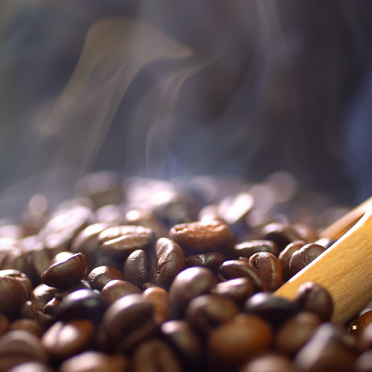 whole bean decaf coffee with wooden scoop inserted
