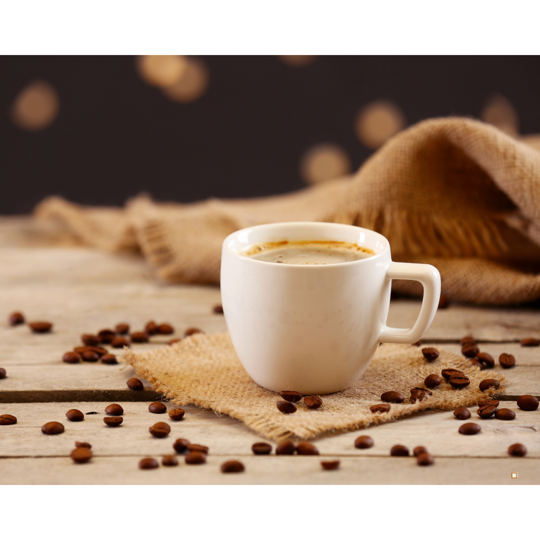 brewed cup of whole bean decaf coffee and coffee beans on table