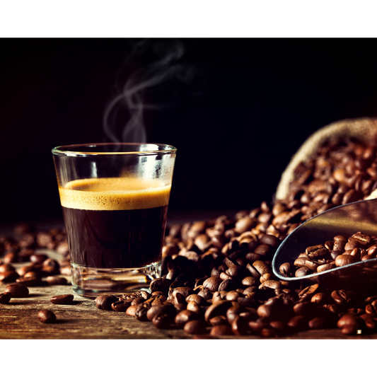 ethiopian yirgacheffe coffee in a clear glass mug surrounded by coffee beans