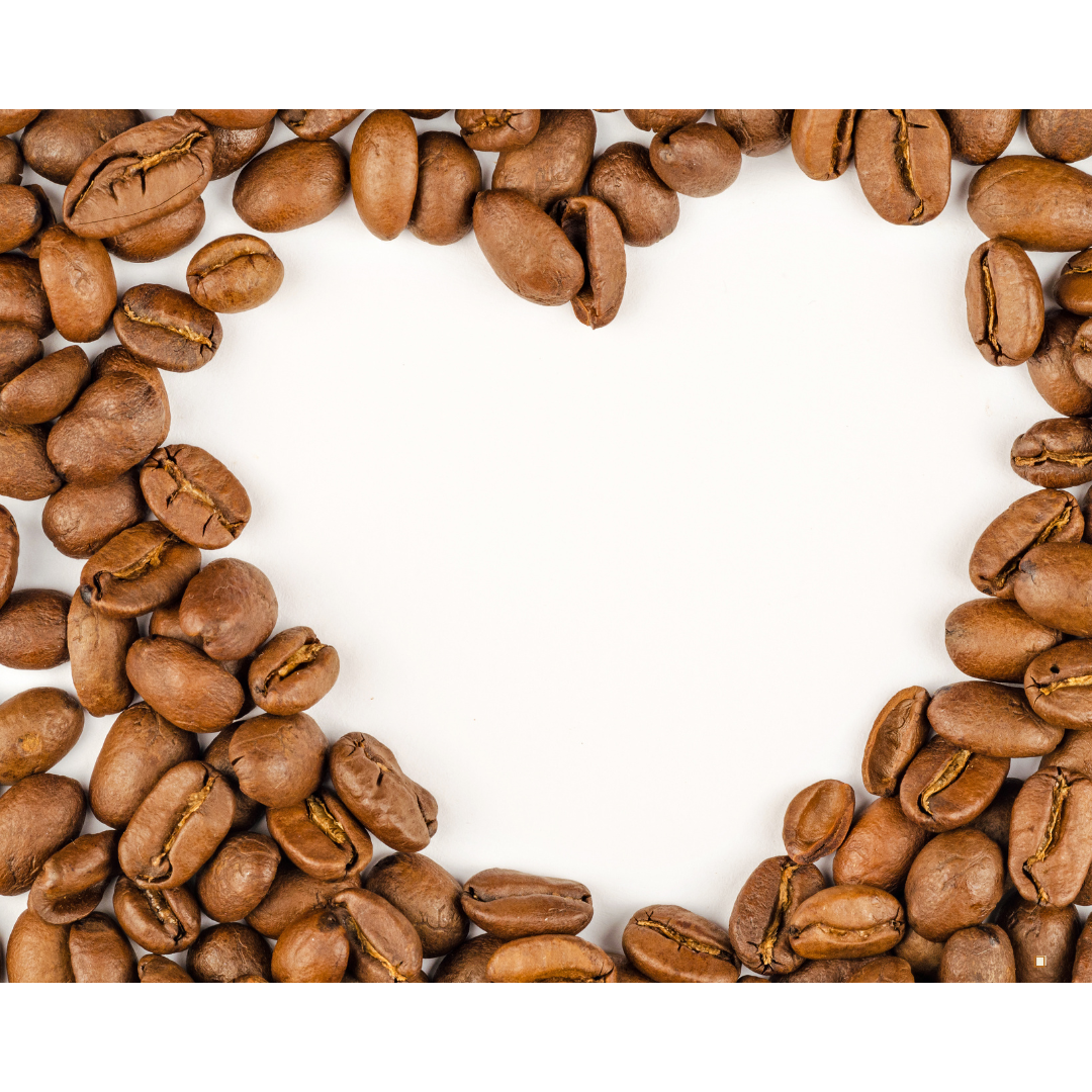 fresh roasted light roast coffee beans arranged in a heart shape