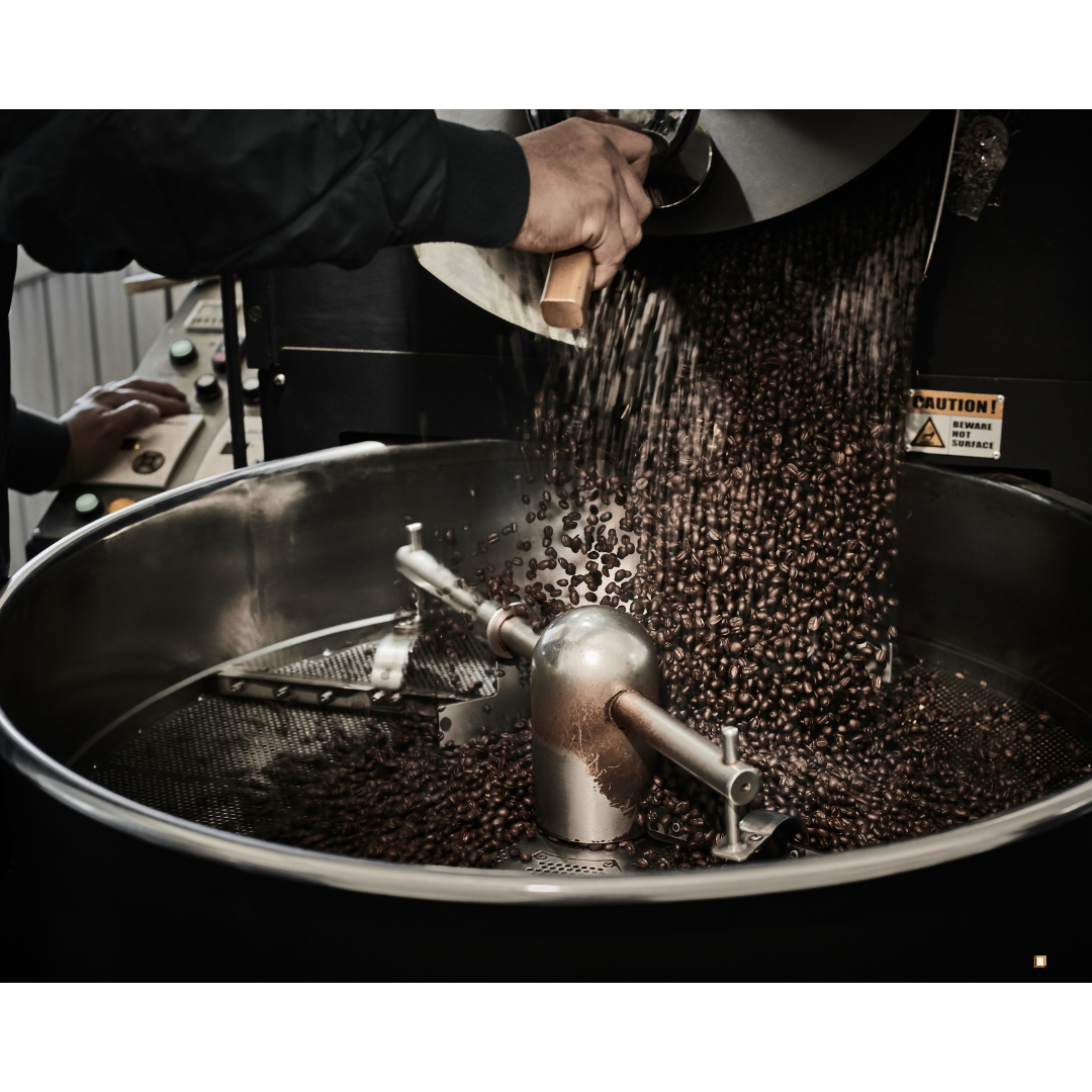 small batch coffee beans emptying into cooling bin
