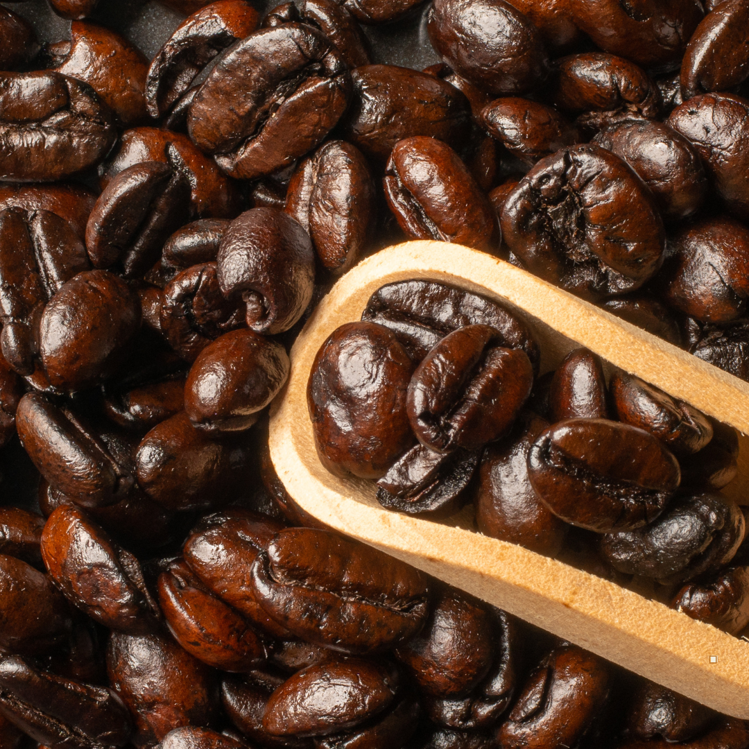 small batch coffee beans in a wooden scoop