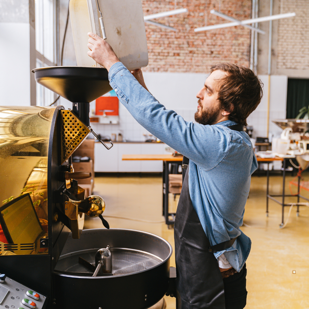 small batch coffee roaster pouring in green beans