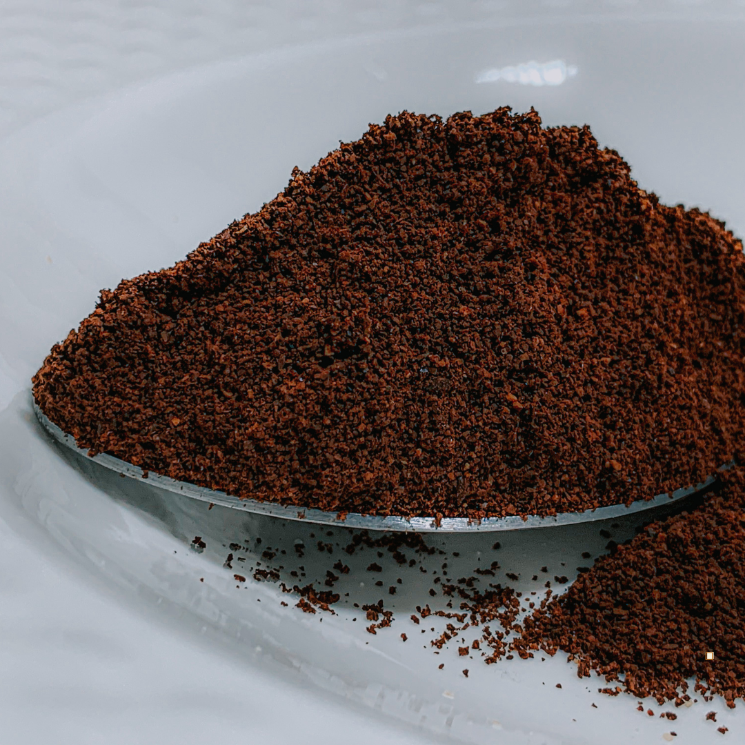 small batch roasted decaf ground coffee in a spoon