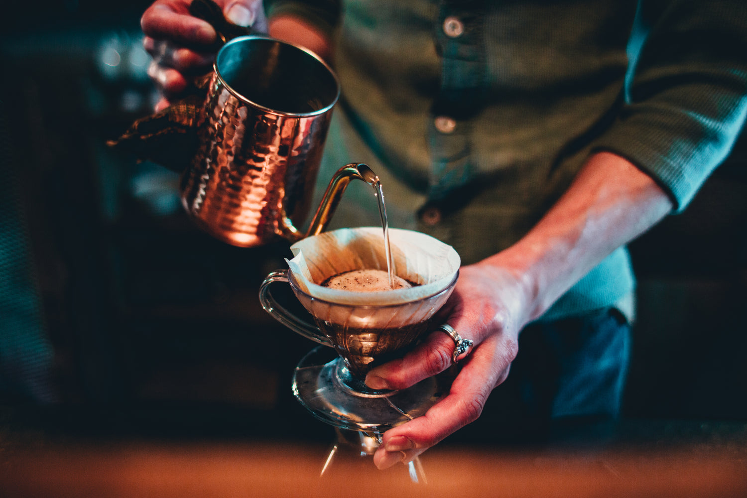 pour over small batch coffee from brass mug